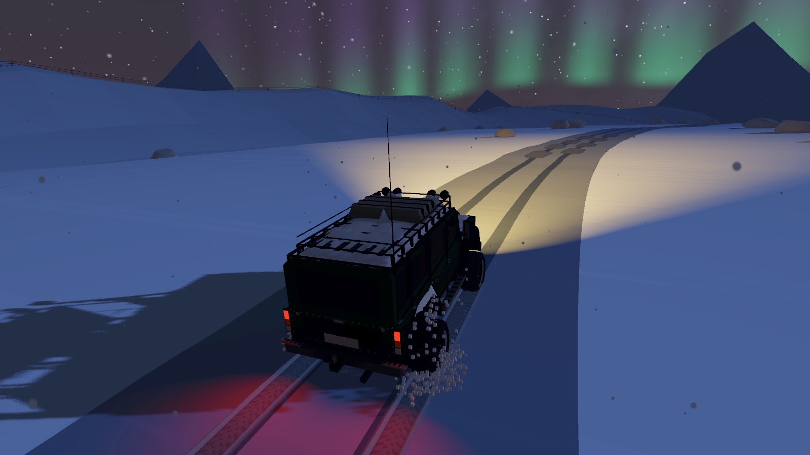 The truck driving through snow at night under the northern lights